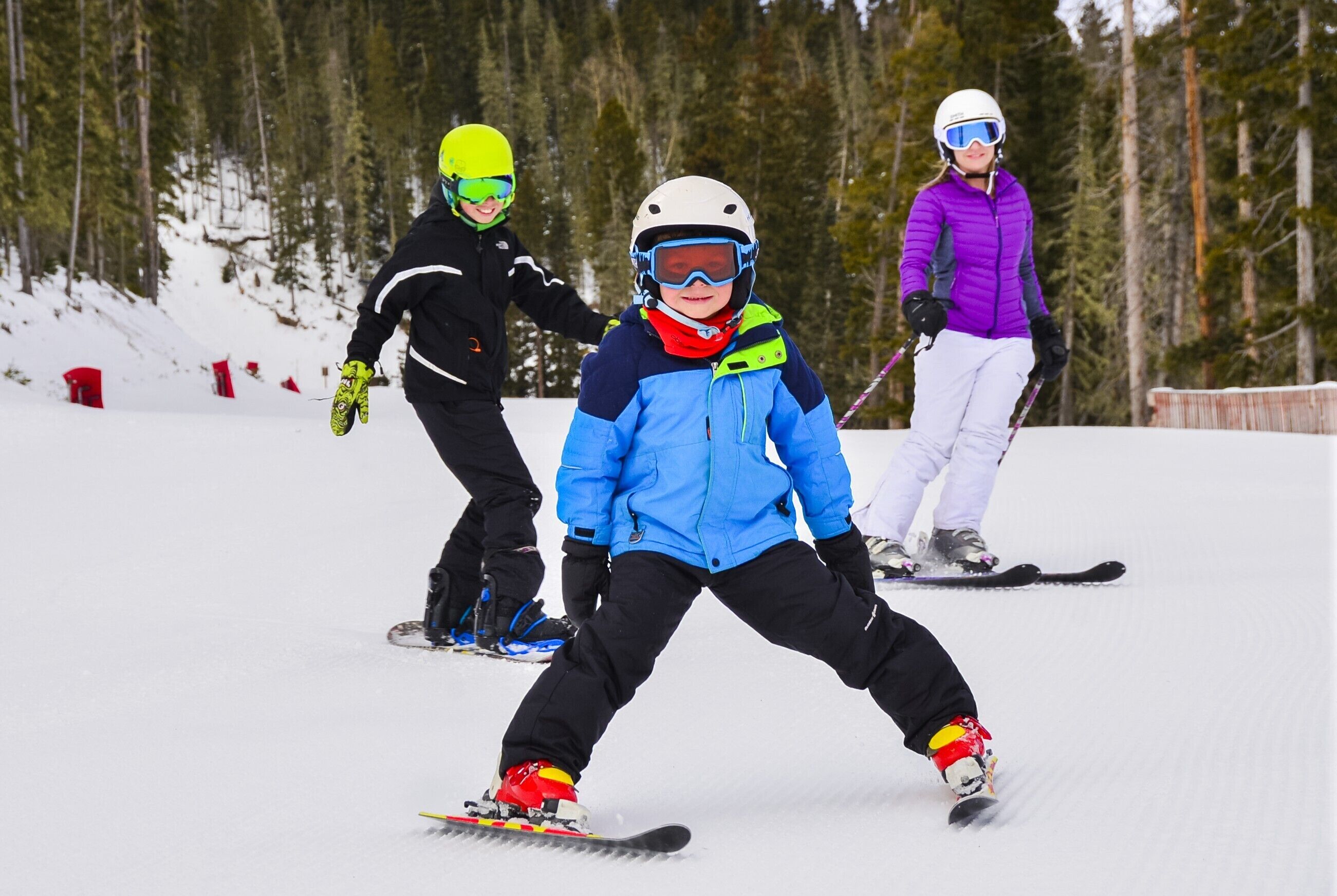 A snowy ski slope with skiers.