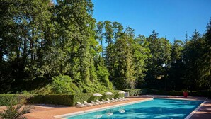 A rectangular swimming pool with a clear blue water surface, surrounded by a paved deck. - RELAXING MOBILE HOME AND FRIENDLY POOL (Saint-Chéron)