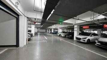 A multi-level parking garage with several cars parked.
