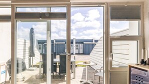 A modern room with a sliding glass door leading to an outdoor patio area. - 4 Person Holiday Home in Vestervig (Vestervig)