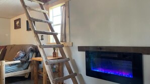 Een houten ladder staat tegen een muur, met een ingebouwd aquarium.