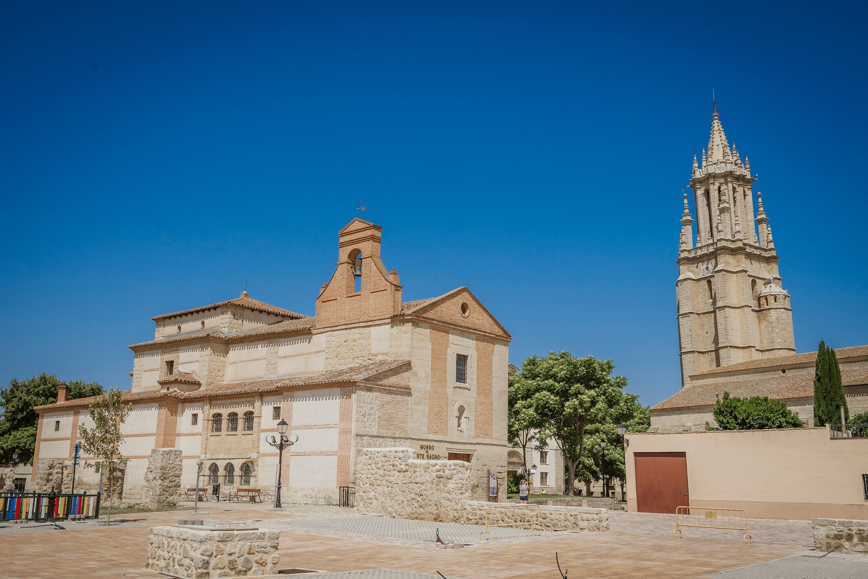 A historic building with a bell tower and a courtyard.