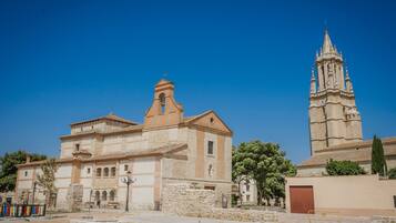 A historic building with a bell tower and a courtyard.