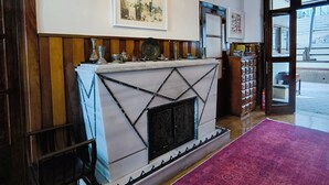 A room with a fireplace, a large rug, and a chandelier. - Palm Villa  (Adalar)