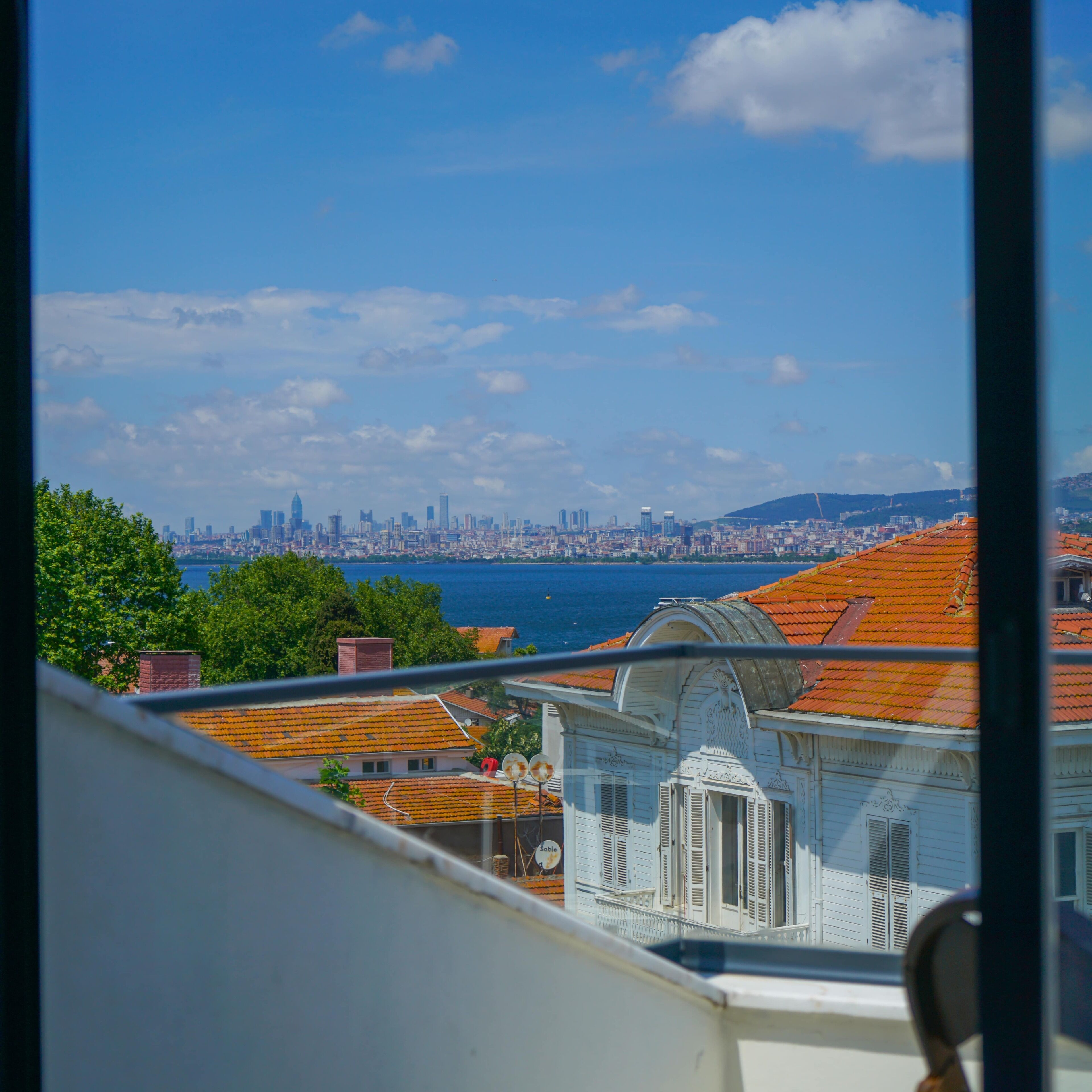 A view of a coastal cityscape with a prominent skyline, including a mix of modern and traditional architecture.