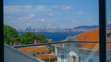 A view of a coastal cityscape with a prominent skyline, including a mix of modern and traditional architecture.