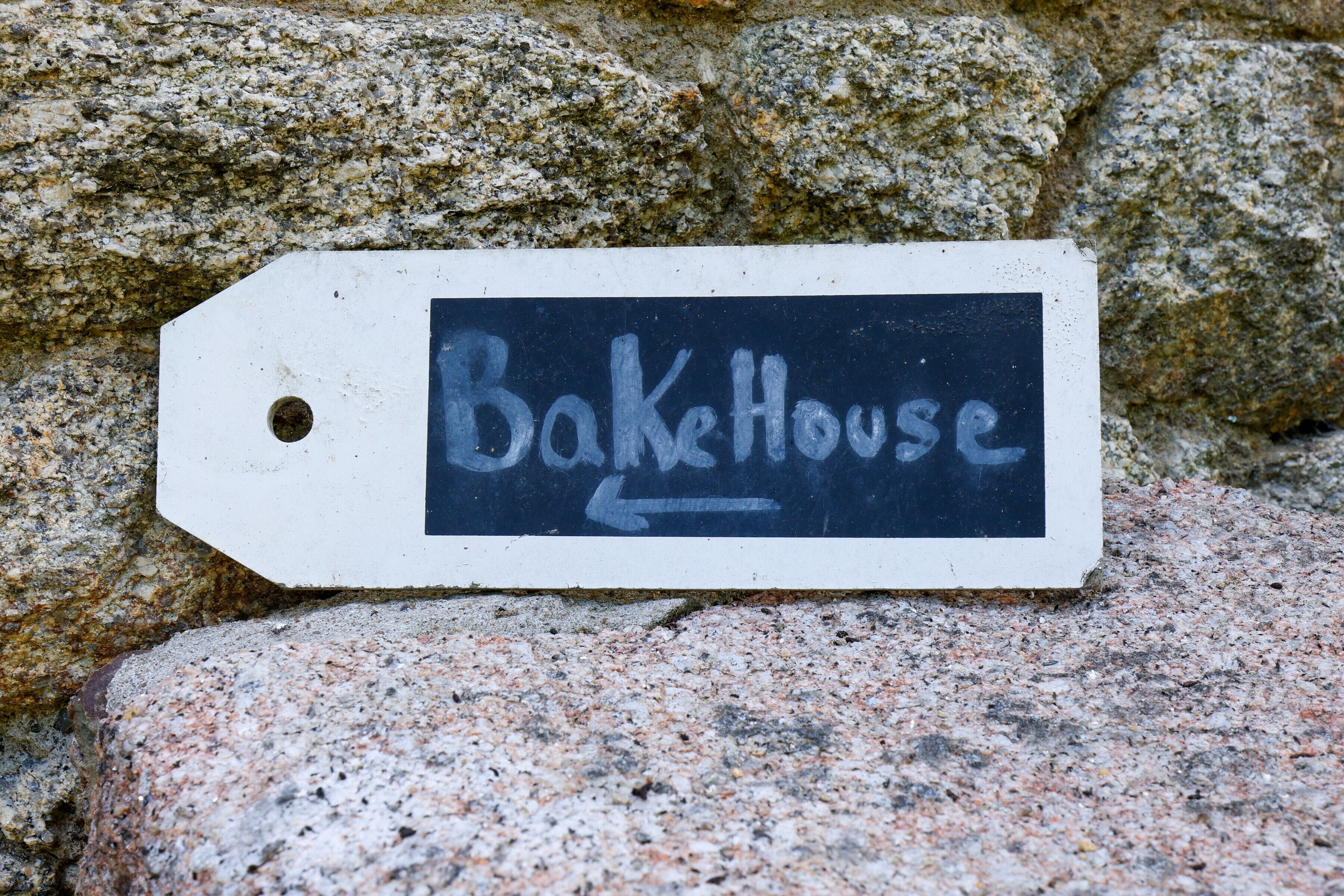 A sign with the text 'BakeHouse' and an arrow pointing left.