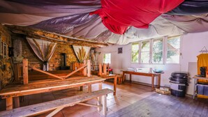 Una habitación rústica con un banco de madera, una mesa y una ventana.