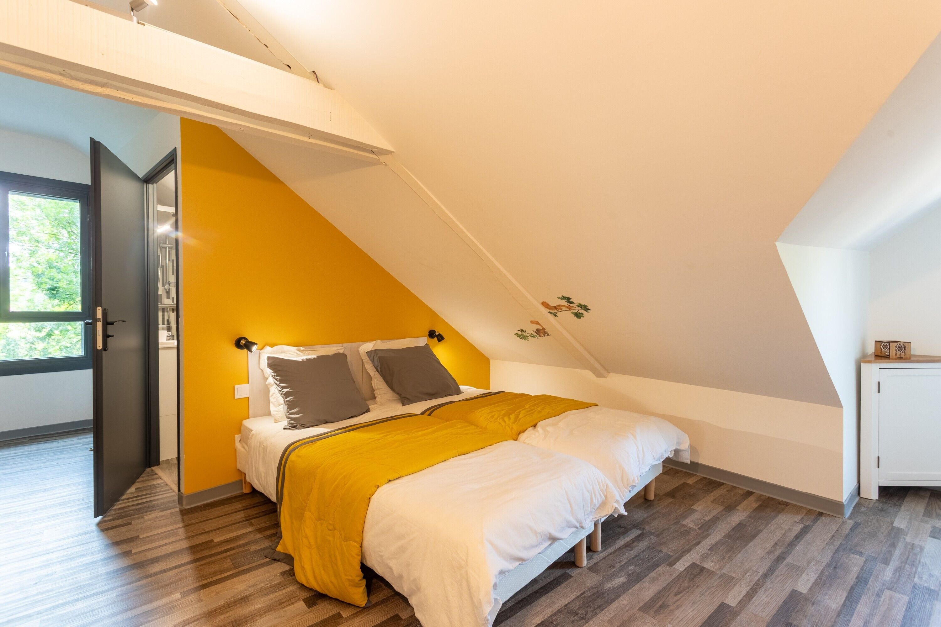 A bedroom with a bed, a wardrobe, and a window.