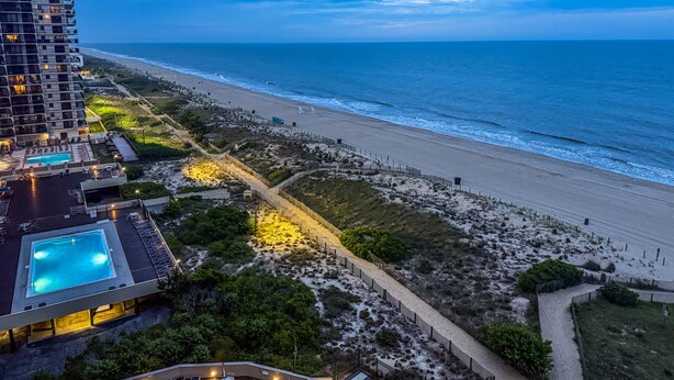 A beachfront hotel with a swimming pool, beach access, and a view of the ocean. - Oceanfront l Pool l Elevator l Private Balcony with Sunrise views (Ocean City)