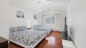 A bedroom with two beds, a window with curtains, a ceiling light, and a TV. - Stripside Serenity –  4B3B Family Retreat, 5 mins from the strip (Las Vegas)
