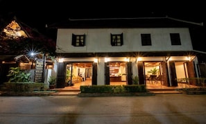 A two-story building with a welcoming entrance, a visible bar area, and a well-lit facade.