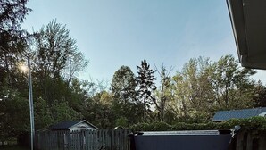 A hot tub in a backyard with a wooden fence and trees in the background. - Chic Dunes Cottage W/ HOT TUB near Warren Dunes / Lake MI! (Shorewood-Tower Hills-Harbert)