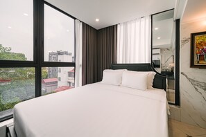 A modern hotel room with a large bed, a view of the city, and a marble wall. - Bay Luxury Boutique Hotel & Spa - No1 Ngo Huyen (Hanoi)