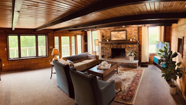 A cozy living room with a fireplace, a sofa, and a coffee table. - >>The Daydream Lodge<<
@Racers Ridge (Plymouth)