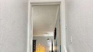A staircase with blue steps leading to a room with a white door. - Charming 2-bedroom apartment in Pleasant Blasdell with morning breakfast. (Blasdell)