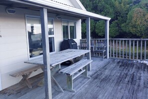 Outdoor dining - Family friendly bach – relax on the deck and soak in the ocean views (Cape Palliser)