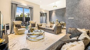 A spacious living room with a large sofa, armchairs, and a coffee table. - Stylish 4BR Family Villa – Easy Access to Dubai Marina & Expo City (Dubai)