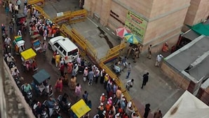 A crowded urban area with a large building featuring an arched entrance and a flat roof. - kailash pati guest house (Varanasi)