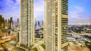 Two high-rise buildings with a cityscape in the background.