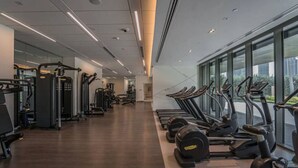 A modern gym with cardio equipment, weight machines, and a spacious layout.