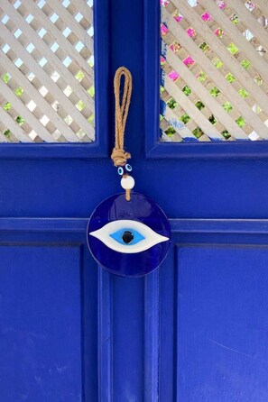 A blue door with a decorative blue eye charm hanging on it. - Kavala Hotel Bodrum (Bodrum)
