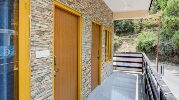 Un bâtiment aux murs revêtus d’un enduit imitant la pierre et aux portes en bois bordées d’un liseré jaune.