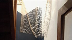 A staircase with wooden steps and a netted decoration hanging from the ceiling. - House "Chez Simone" Le Tréport Walks or bike rides Pets welcome! (Le Tréport)