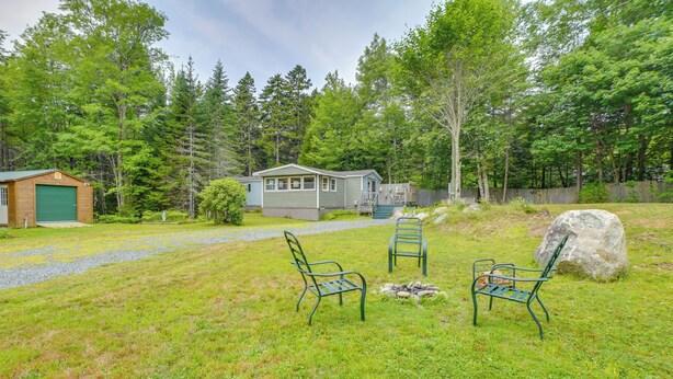 A cabin with a porch, a fire pit, and two chairs in a grassy yard. - 13 Mi to Acadia: Artistic Retreat in Nature (Trenton)