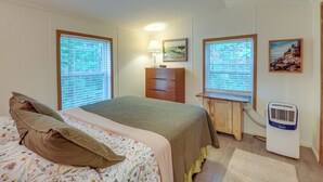 A bedroom with a bed, a dresser, a lamp, a heater, and two windows with blinds. - 13 Mi to Acadia: Artistic Retreat in Nature (Trenton)