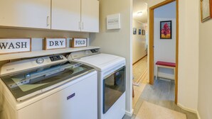 A laundry area with a Maytag washer and dryer, a drying rack, and signs indicating 'WASH,' 'DRY,' and 'FOLD.' - 13 Mi to Acadia: Artistic Retreat in Nature (Trenton)