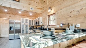 A modern kitchen with wooden walls, a marble countertop, and stainless steel appliances. - Sip, Hike & Explore: Sleek Retreat in Cleveland! (Cleveland)