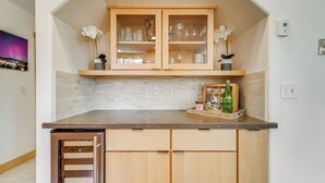 A kitchen with wooden cabinets, a countertop, and a built-in dishwasher.