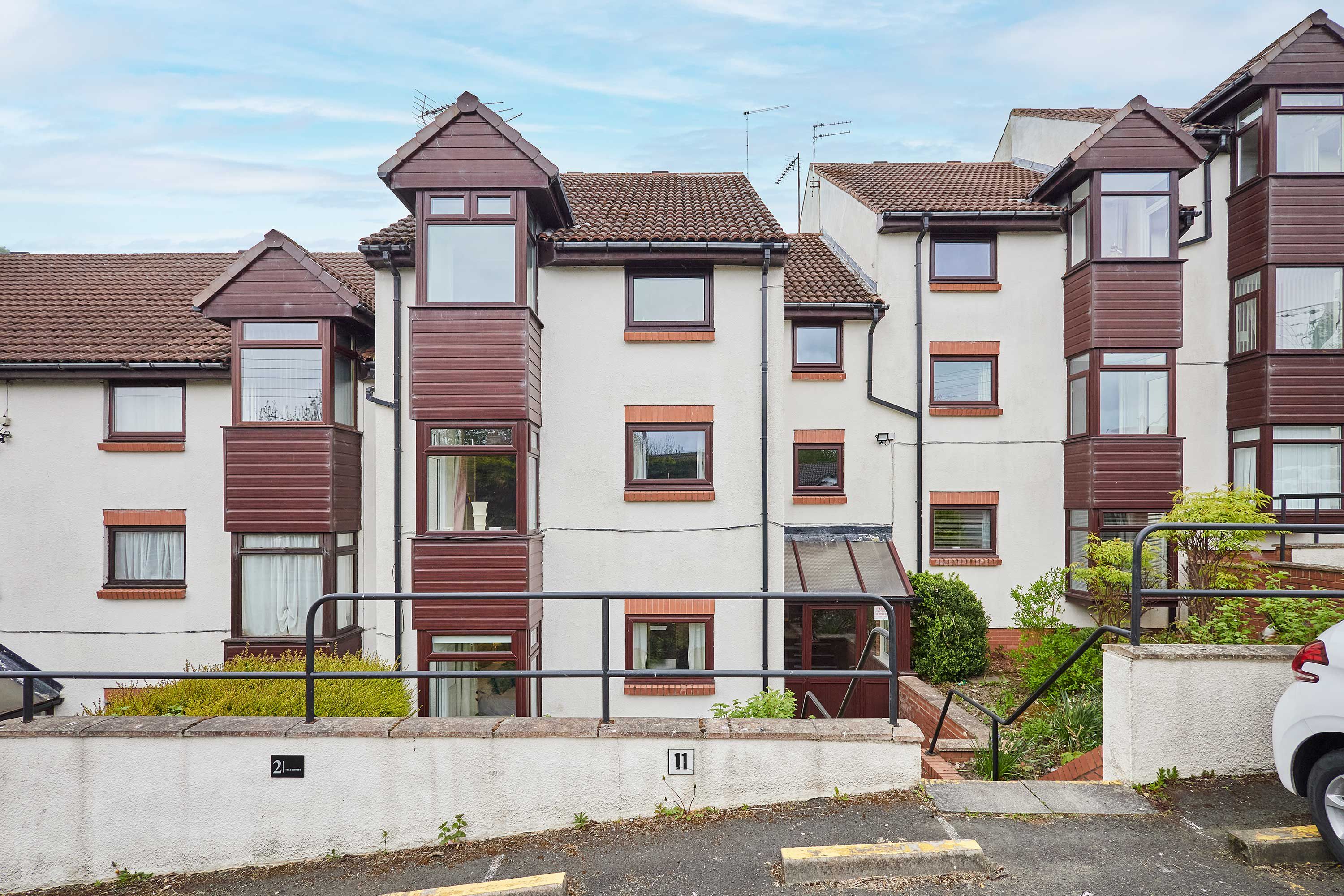 A row of terraced houses with a consistent architectural style, featuring pitched roofs and multiple windows.