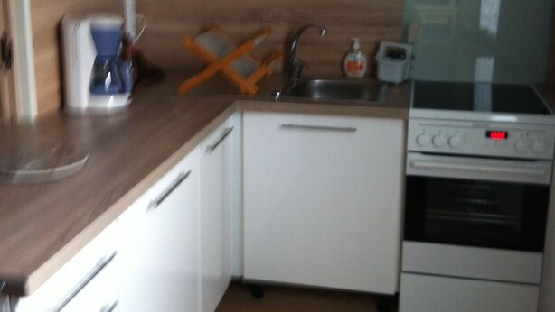 A compact kitchen with white cabinets, a wooden countertop, a sink, a stove, and a dishwasher. - Village house sleeps 6 near ST CROIX DU VERDON (Roumoules)