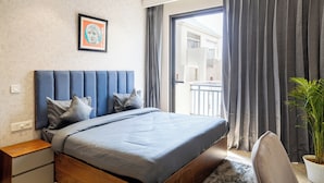 Quarto moderno com uma cama grande, cabeceira, mesa de cabeceira, planta em vaso e vista para o exterior.