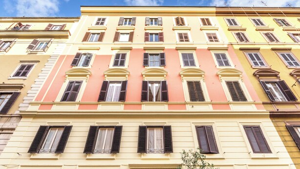 A multi-story building with a row of windows and balconies.