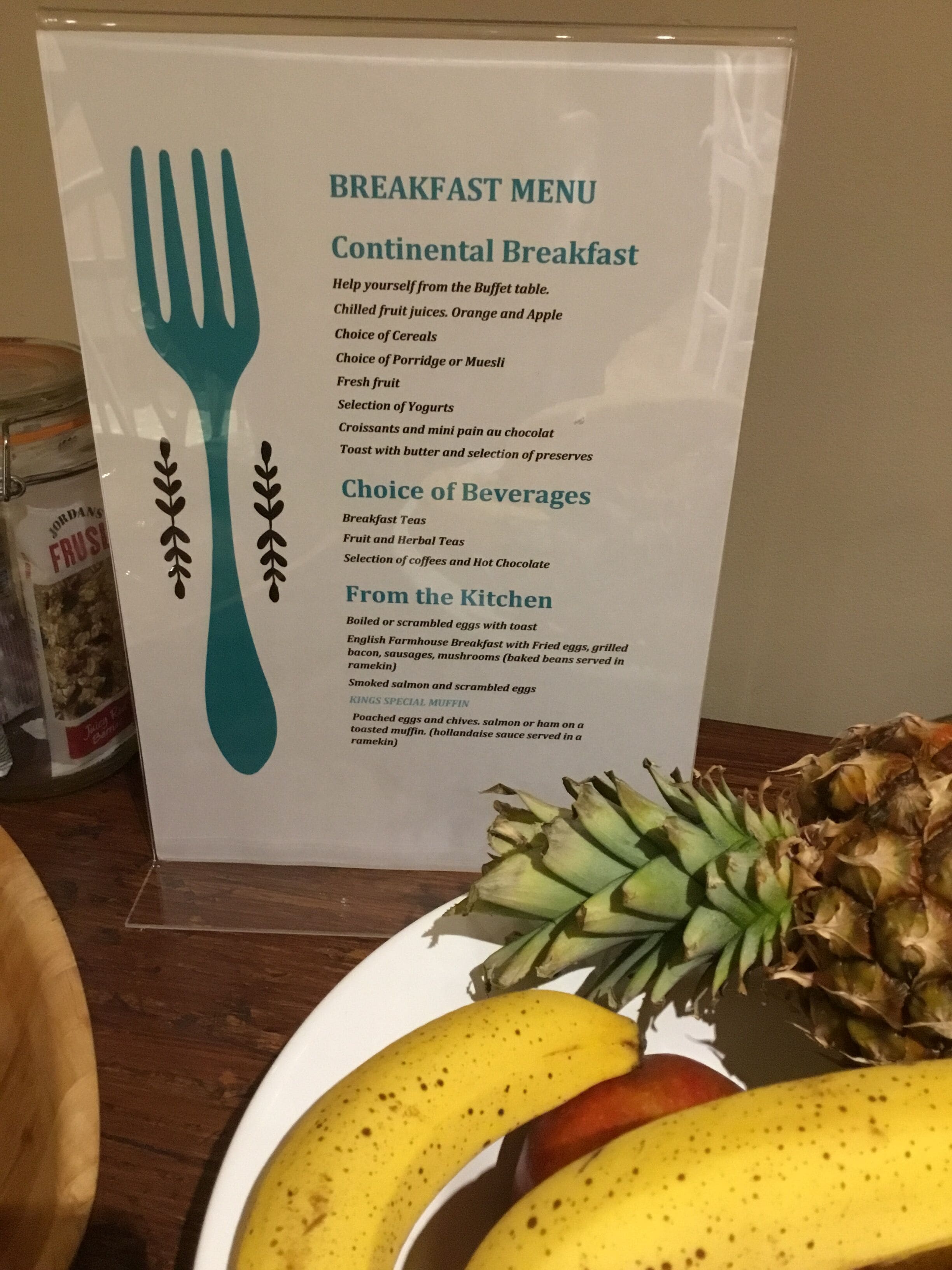A breakfast menu board with options for continental breakfast, beverages, and from the kitchen.