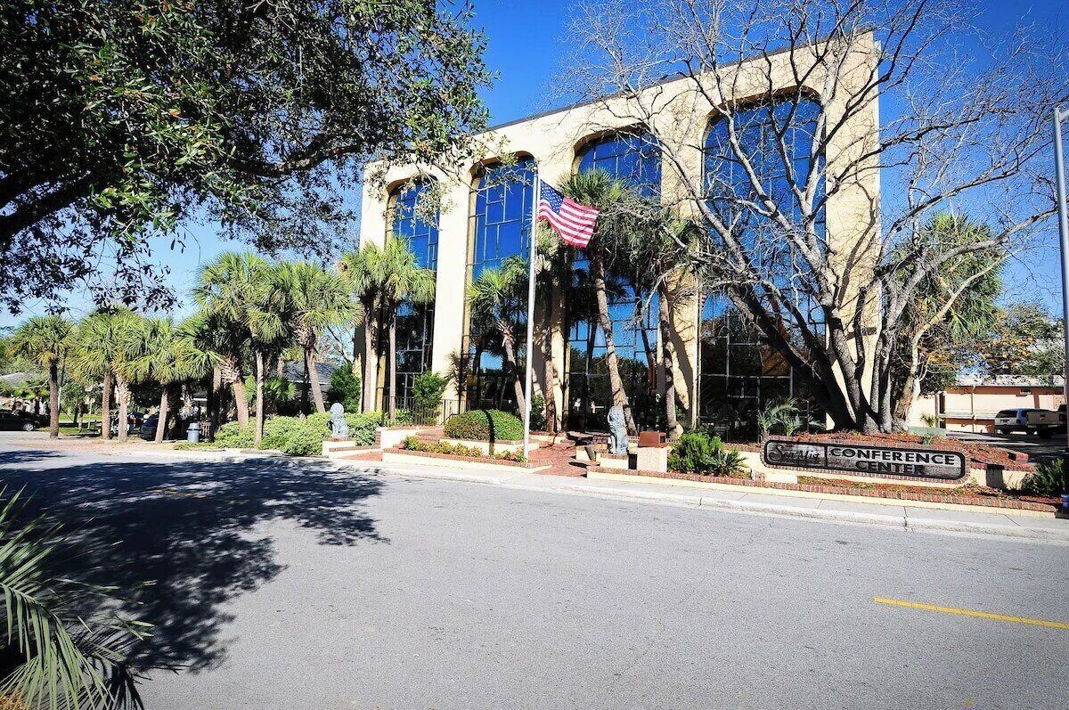 A building with a sign reading 'CONFERENCE CENTER' and an American flag.
