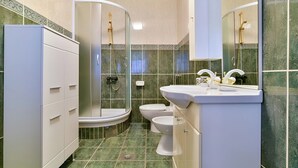 A bathroom with a toilet, bidet, and a sink with a mirror. - Apartment RuzicaCharming 1-bedroom apartment with Sveti Stefan (sveti stefan)