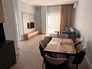 Apartment | Living area | 50-inch flat-screen TV with satellite channels