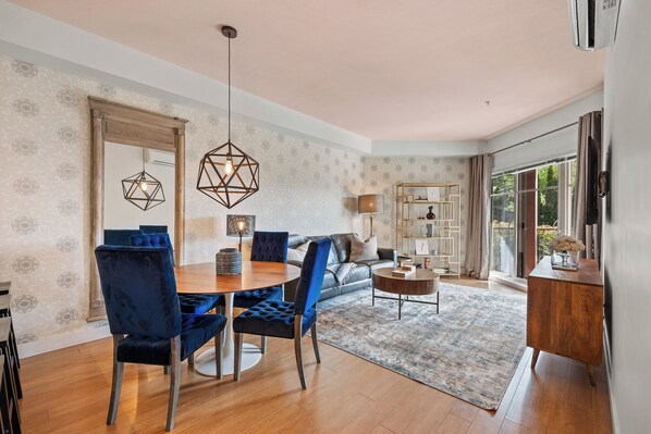 A modern living room with a dining area, a sofa, and a coffee table.