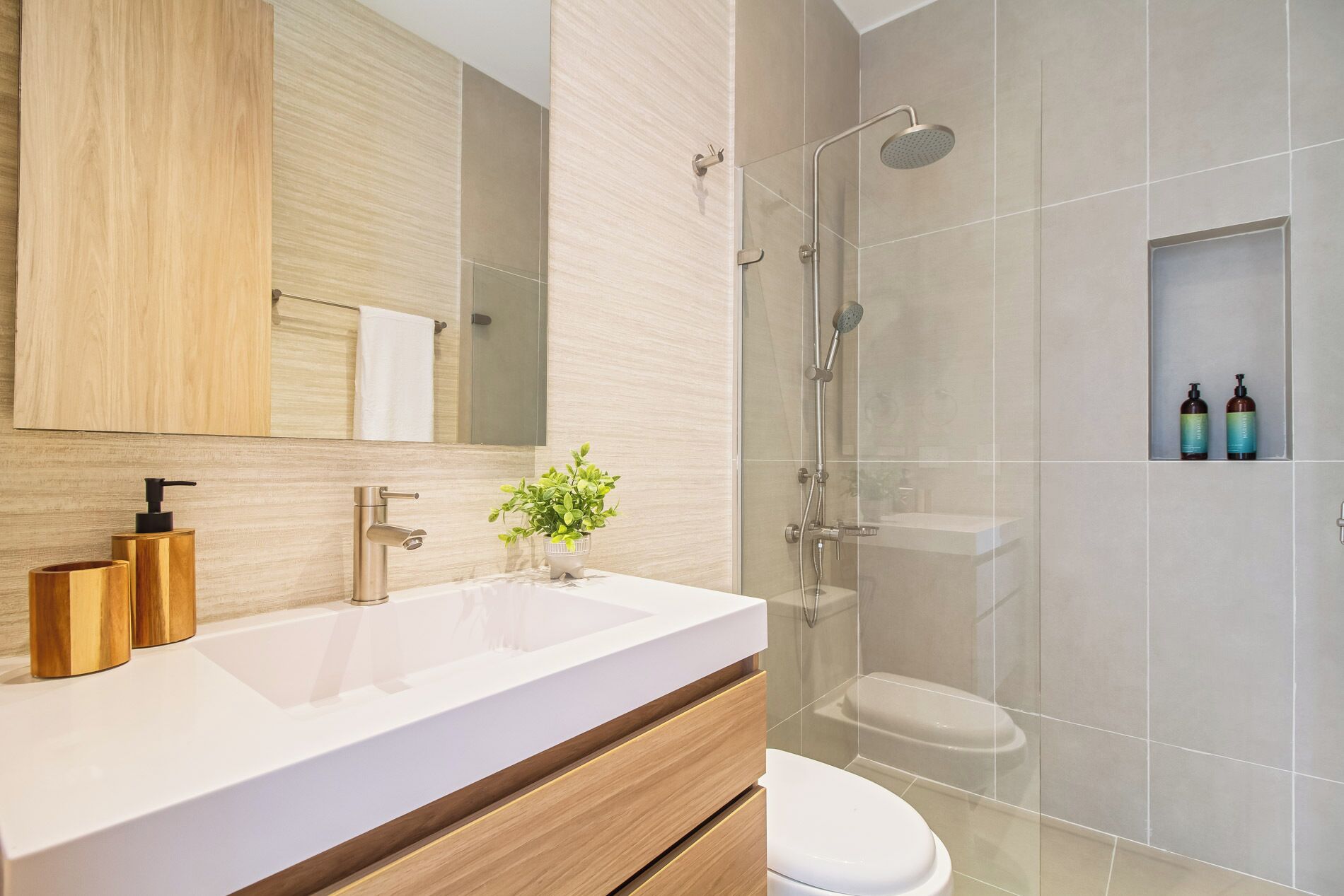 Een moderne badkamer met een groot wastafel, toilet en douchehoek.
