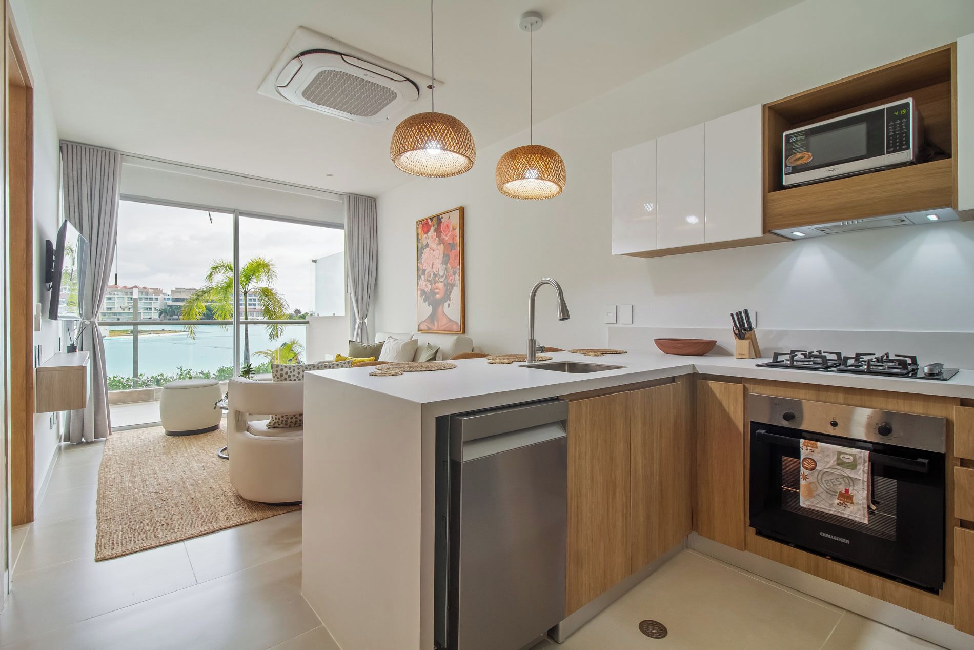 A modern kitchen with a central island, stainless steel appliances, and a view of a pool.