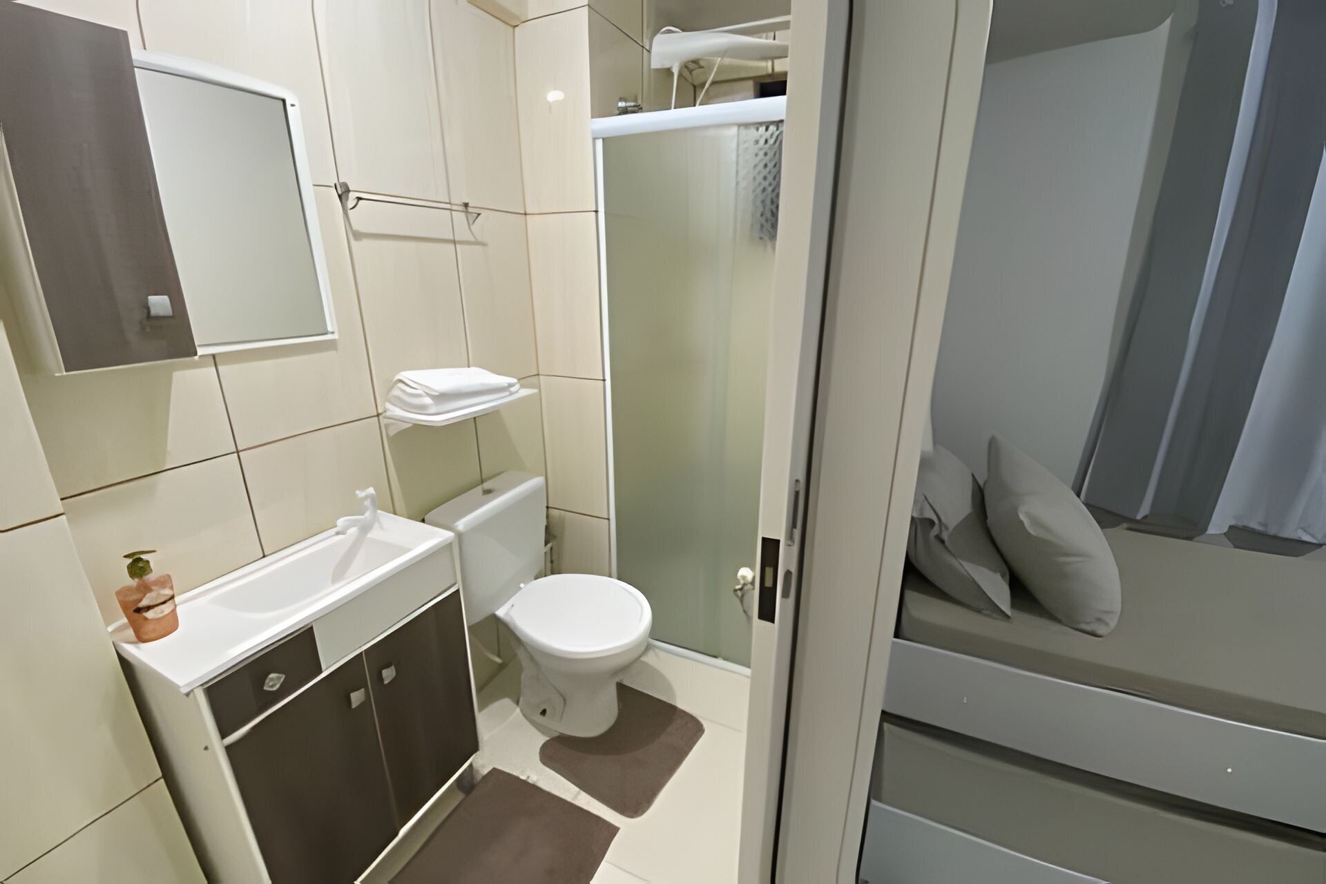 A modern bathroom with a toilet, sink, and shower.