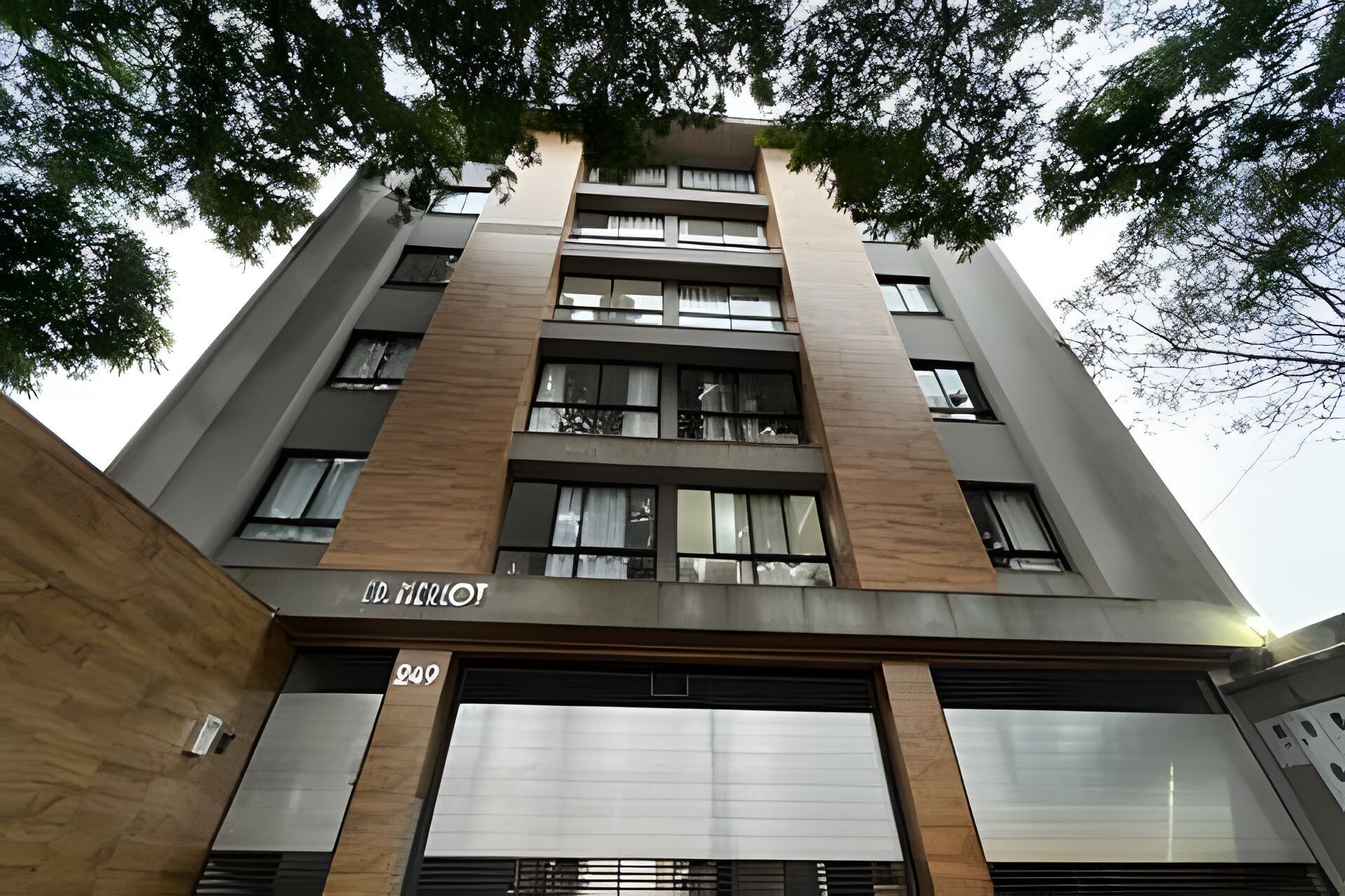 A modern building with a flat roof, large windows, and a sign with the number 949.