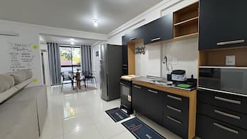 Basic Apartment | Private kitchen | Fridge, microwave, cookware/dishes/utensils, dining tables
