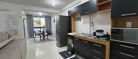 Basic Apartment | Private kitchen | Fridge, microwave, cookware/dishes/utensils, dining tables