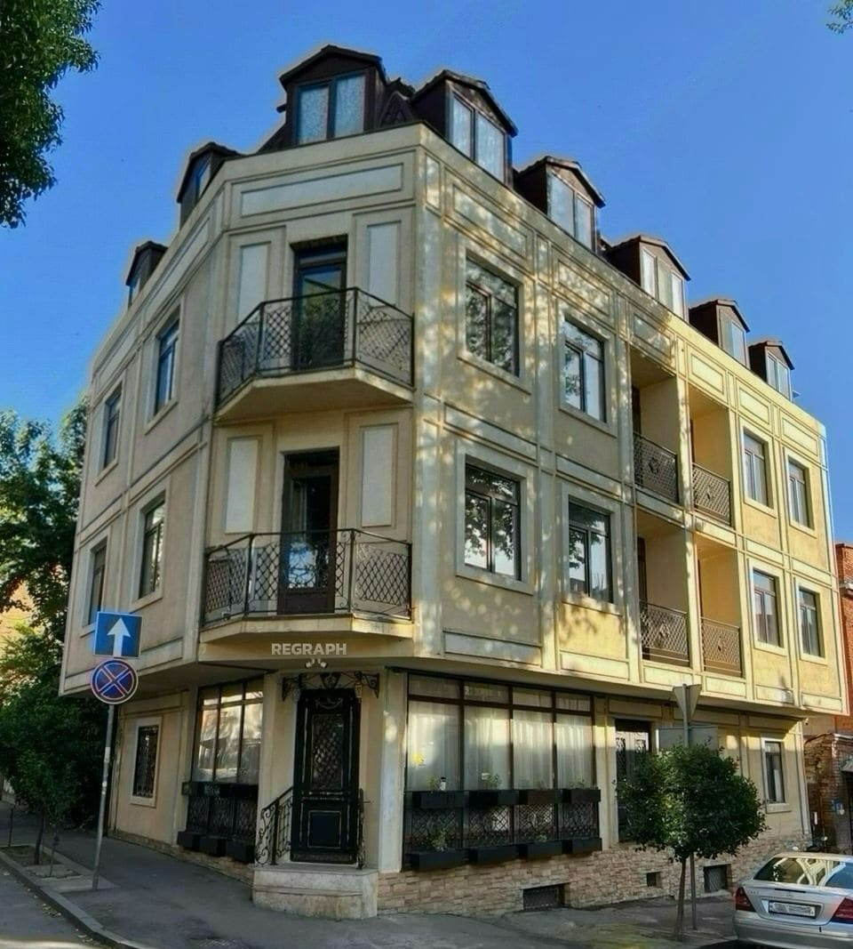 A multi-story building with a ground-floor entrance labeled 'REGRAPH.'