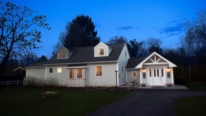A two-story house with a front porch, a garage, and a driveway.